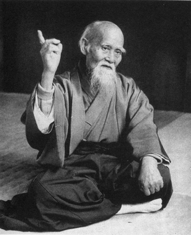 Picture of O Sensei, Morihei Ueshiba sitting cross-legged