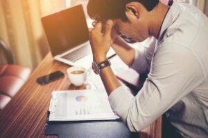 man bent over a desk