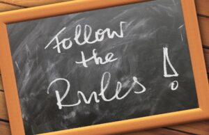 Chalkboard stating 'Follow the Rules!' Suggests that competitive aikido is bad because aikidoka will train to a set of rules